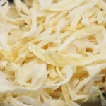 Dehydrated white kibbled onion up close